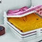 Foldable clothes organizer with t-shirts and belt.
