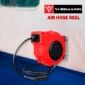 Red air hose reel mounted on wall.
